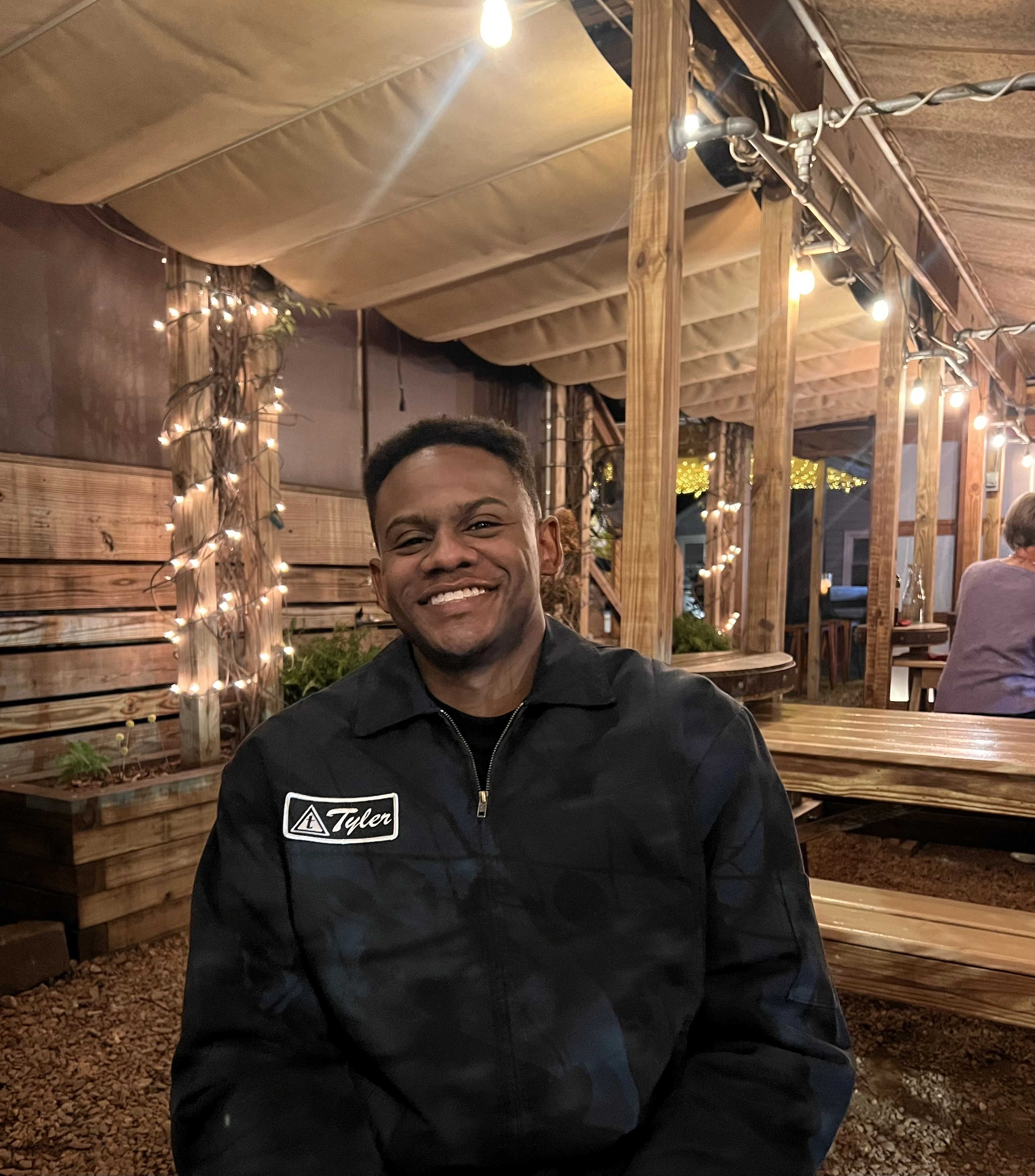 Jordan Bailey smiling in a warmly lit setting